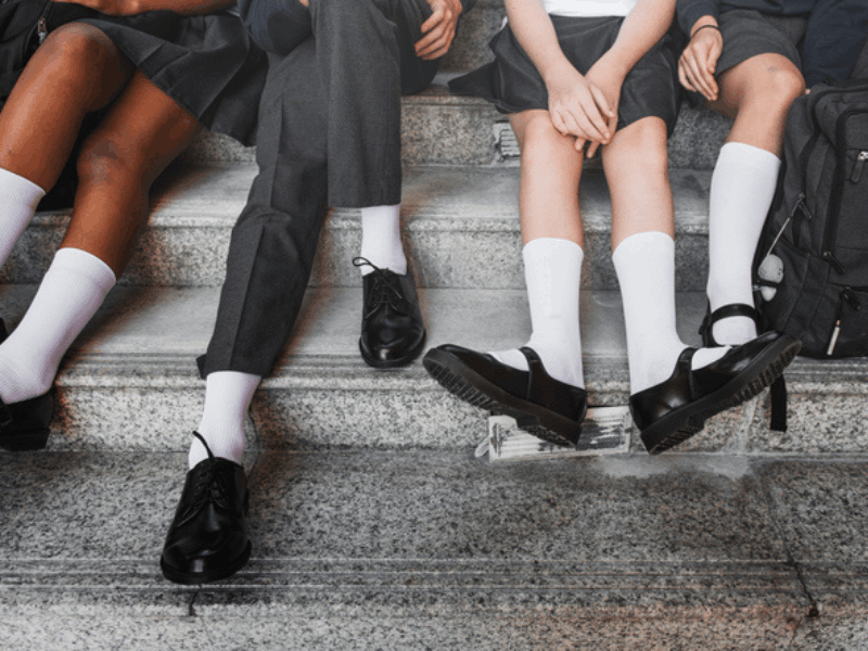 Group of school children wearing grey uniforms