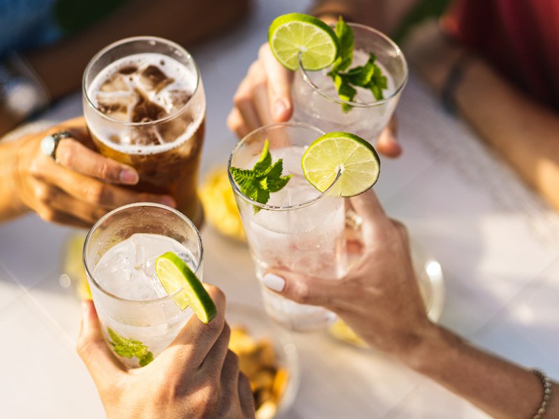 Group of people celebrating toasting with cocktails