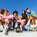 Group of young people friends sitting outdoors