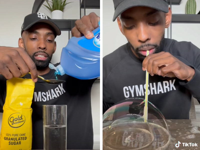 Guy blowing bubbles off a table