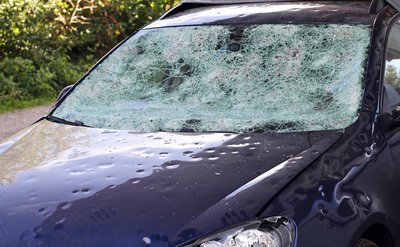 Car after a hailstorm, showing comprehensive coverage benefit