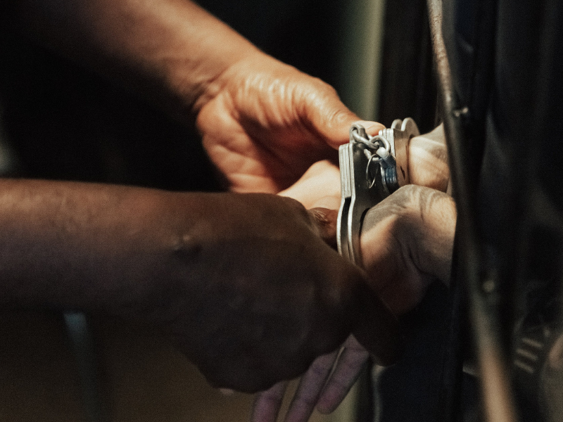 Handcuffs on hands of prisoner in jail
