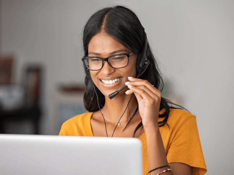 Happy Indian woman working at a call centre
