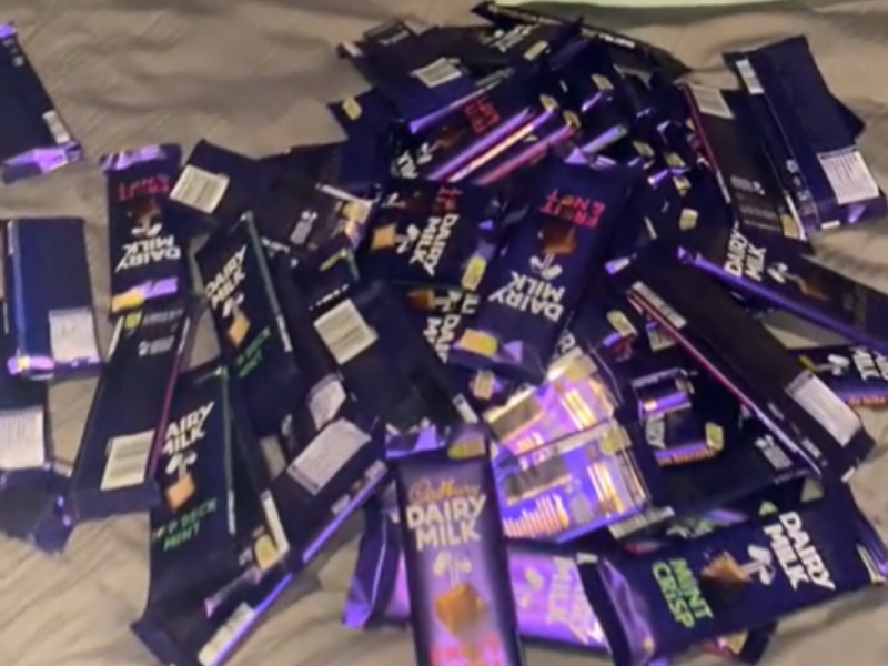Heap of Cadbury slabs lying on the bed