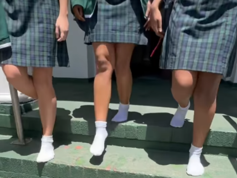 High school girls walk down stairs without their school shoes