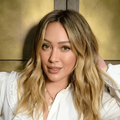Hilary Duff wearing a white blouse with lace details