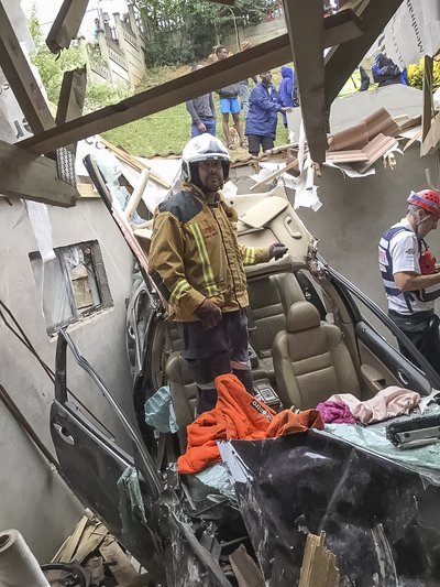 Woman in serious condition, after car smashes through a roof