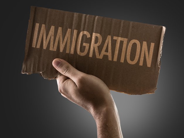 Immigration word written on a cardboard