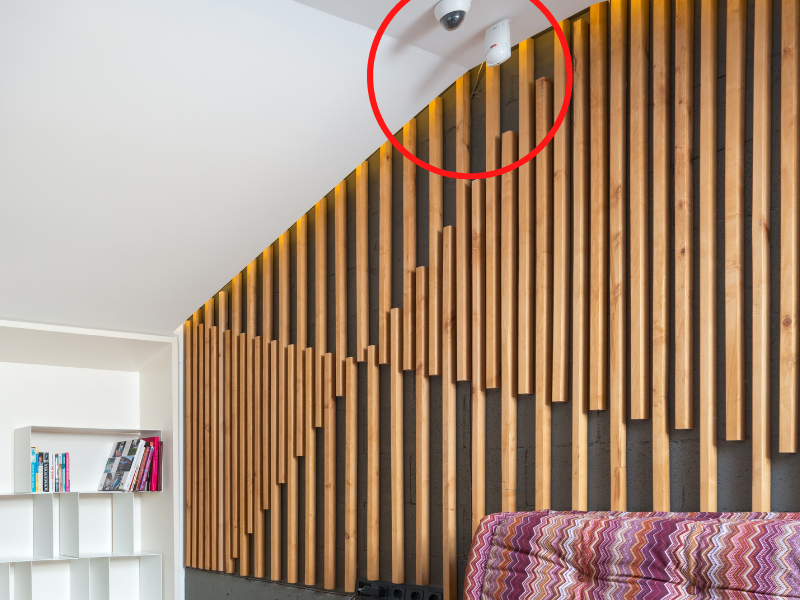 Interior of spacious room with fireplace and security camera