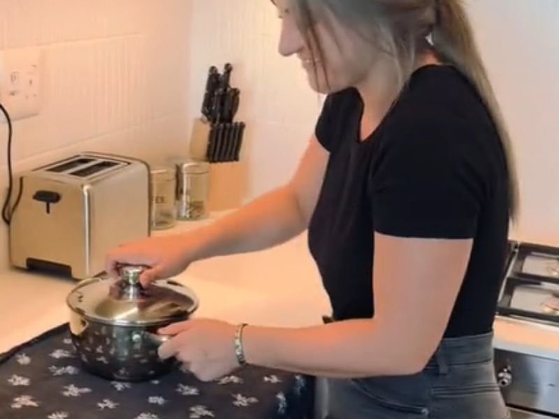 Woman irons with pot