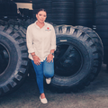 Jasmeena Patel Shiba from Royal Tyres poses near stacked tyres