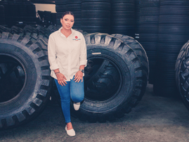 Jasmeena Patel Shiba from Royal Tyres poses near stacked tyres