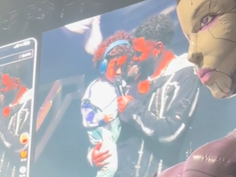 Jason Derulo and his son on stage at a concert