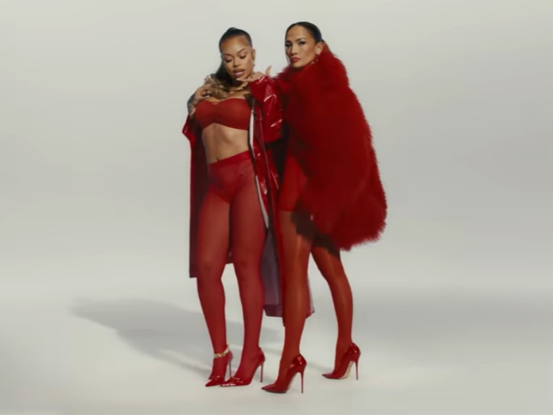 Jennifer Lopez and Latto wearing matching red outfits