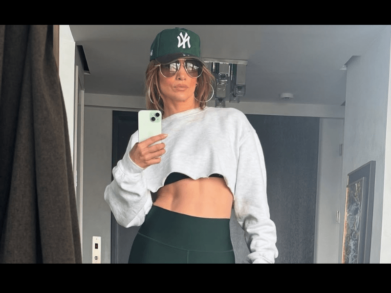 Jennifer Lopez wearing green and white workout clothing