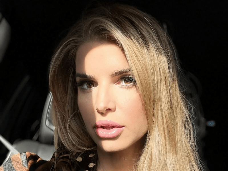 Jessica Simpson wearing hoop earrings takes a car selfie