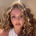 Jesy Nelson with curly blonde hair