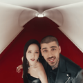 Jisoo and Zayn Malik in a futuristic white tunnel with red floors