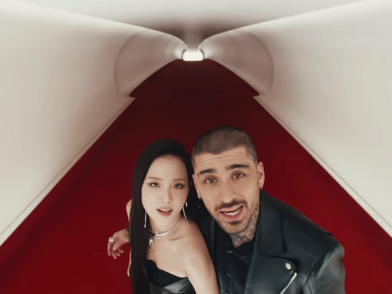 Jisoo and Zayn Malik in a futuristic white tunnel with red floors