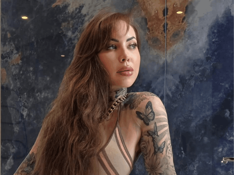 JoJo Robinson poses in a modern bathroom