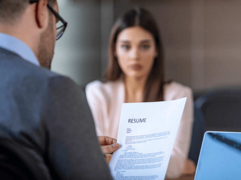 Job interview in office with the focus on the applicants resume