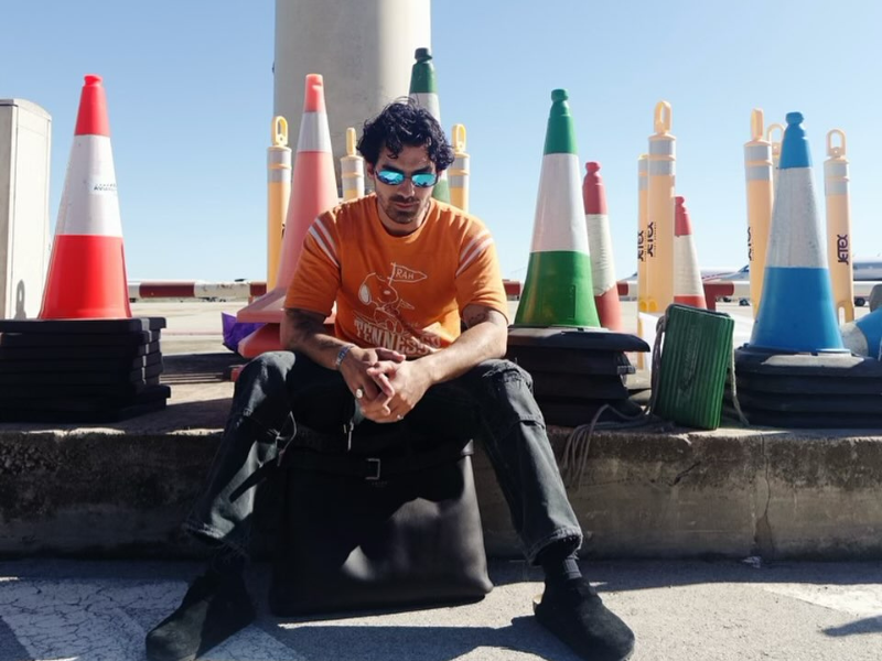 Joe Jonas surrounded by safety cones