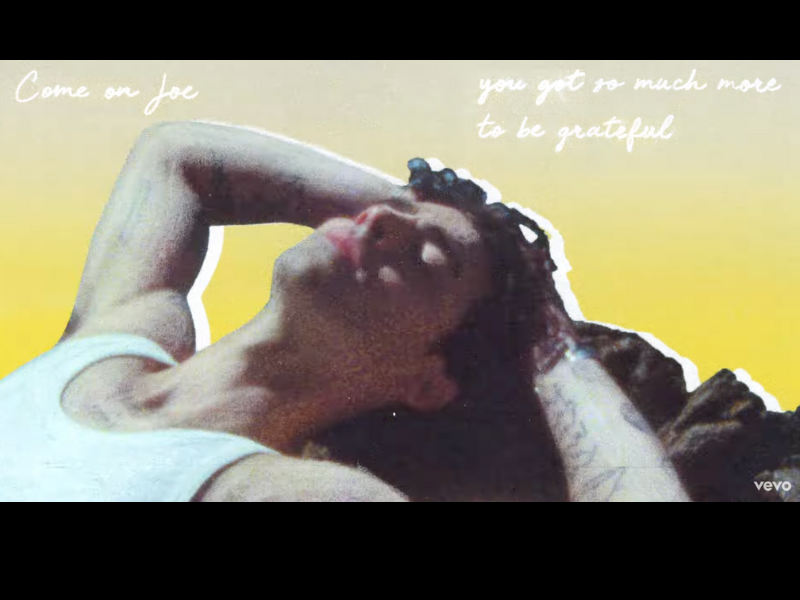 Joe Jonas wearing a white tank top