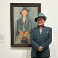 Johnny Depp poses next to a painting of The Little Peasant
