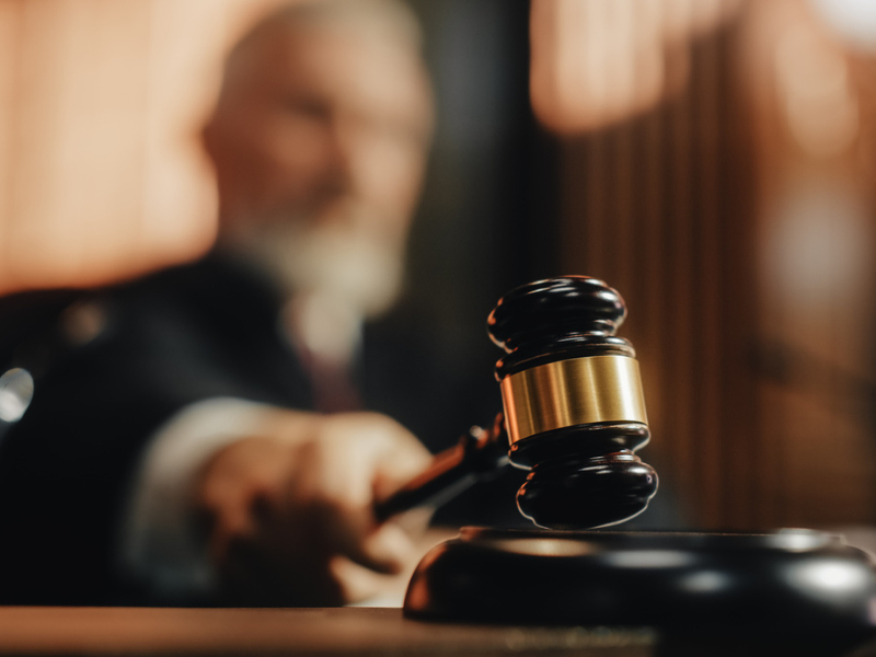 Judge striking a gavel in court