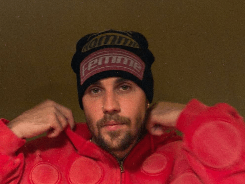 Justin Bieber wearing a black beanie with bold lettering