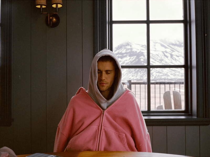 Justin Bieber wearing a grey and pink hoodie