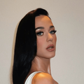 Katy Perry poses against a plain white background
