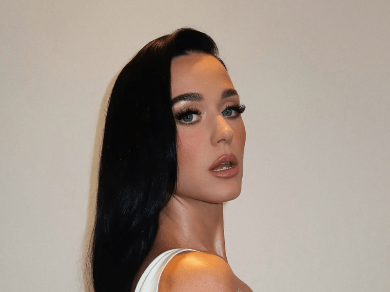 Katy Perry poses against a plain white background
