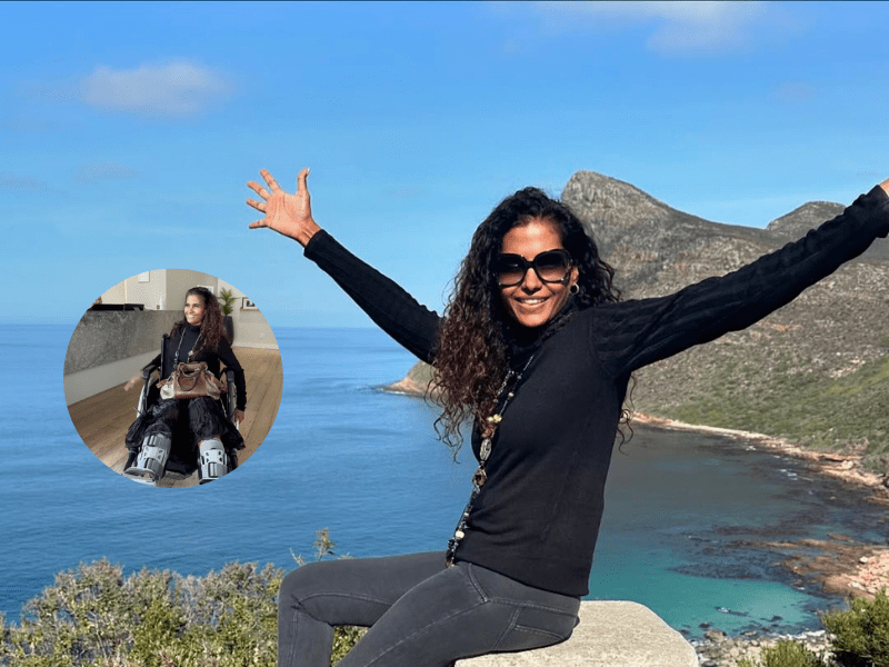 Kerishnie Naiker sitting on a stone ledge in Cape Town