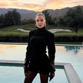 Khloé Kardashian poses beside a modern pool