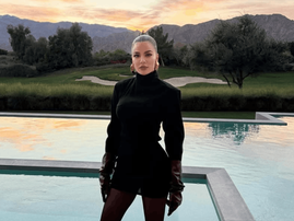 Khloé Kardashian poses beside a modern pool