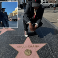 Khuli Chana kneels down in front of his alleged Hollywood star