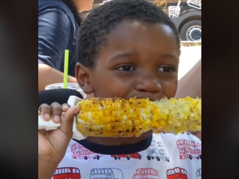 Kid eating corn on the cob