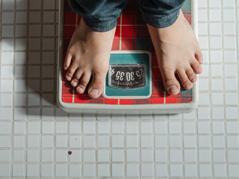 Kid weighing on scale