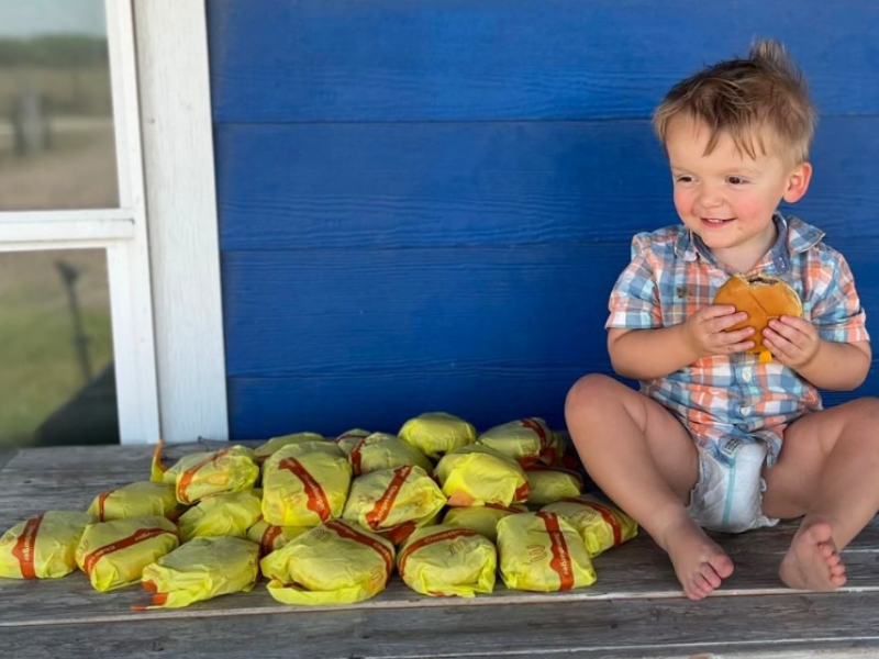 Kid with lots of cheeseburgers
