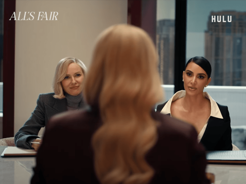 Kim Kardashian and Naomi Watts sitting at a desk