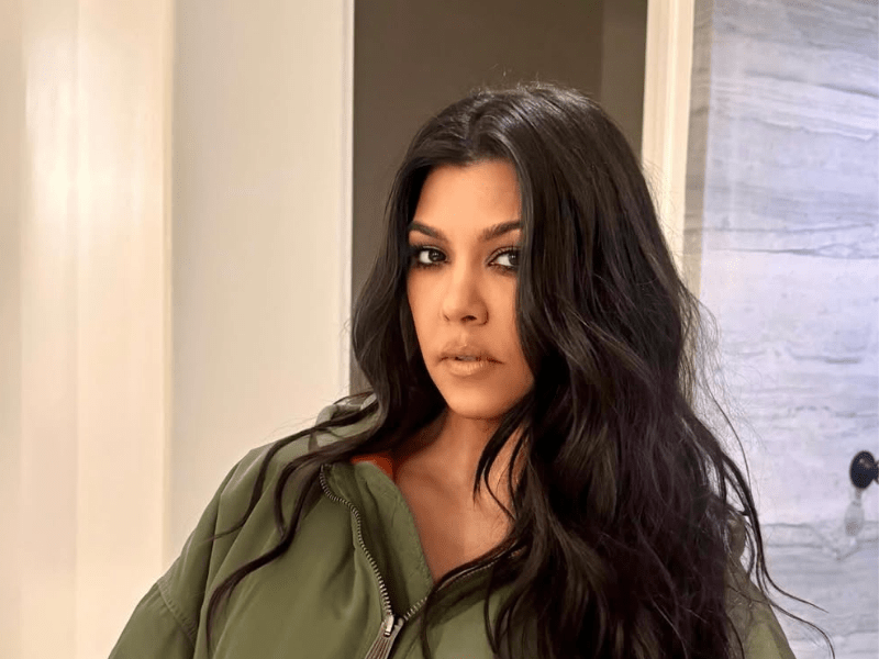 Kourtney Kardashian wearing an oversized green jacket