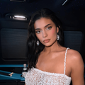 Kylie Jenner wearing a white dress with thin straps
