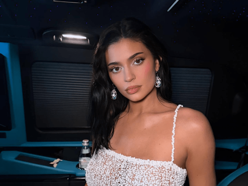 Kylie Jenner wearing a white dress with thin straps