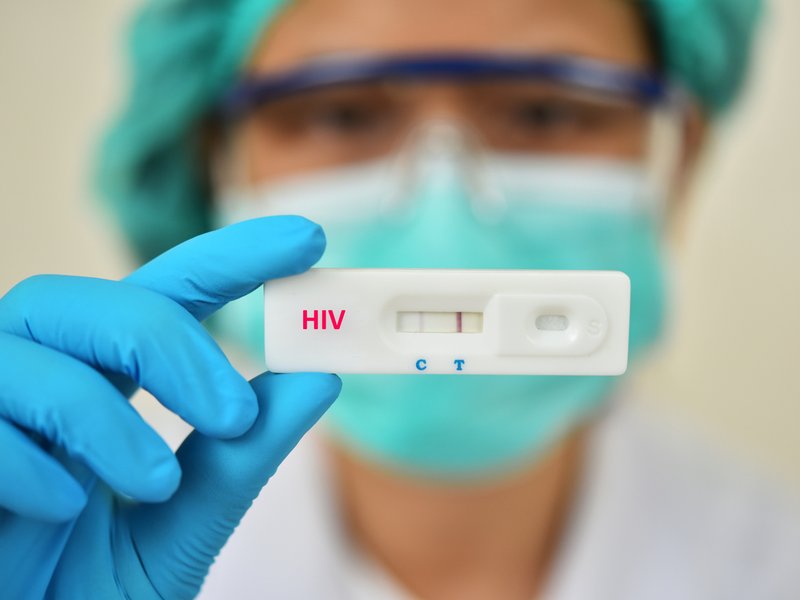 Lab technician holding HIV rapid device test