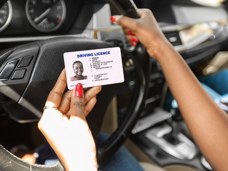 Lady holding her driving licence