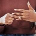 Lady removing ring from hand