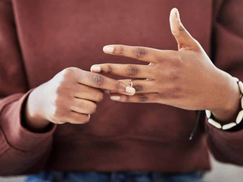 Lady removing ring from hand