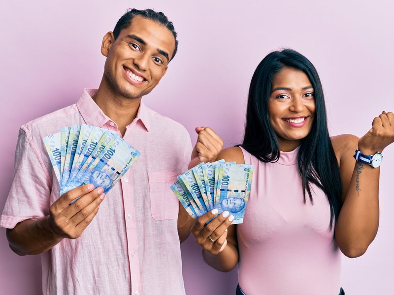 Latin couple holding south african rand banknotes