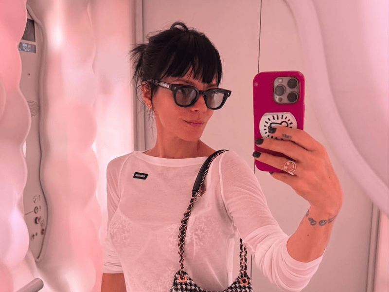 Lily Allen wears a sheer white top while taking a mirror selfie